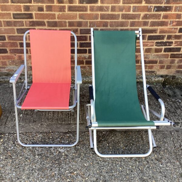 Pair of vintage folding deck chairs in red and green.