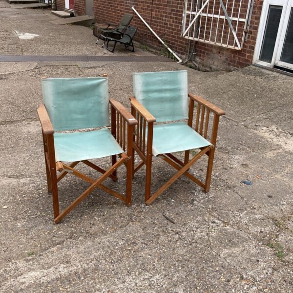 Vintage folding directors chairs in a garden setting.