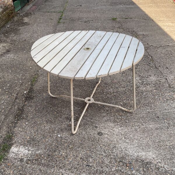 Vintage folding garden table with wooden slats and metal legs.