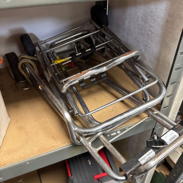 Vintage metal folding luggage trolley for airport or travel use.