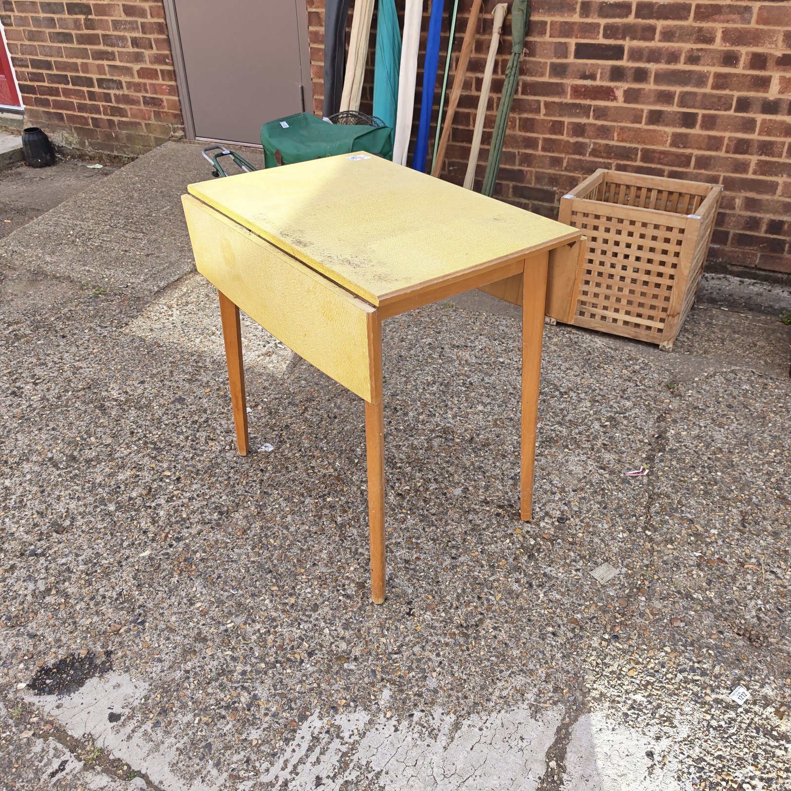 Vintage Formica drop leaf table with wooden legs.