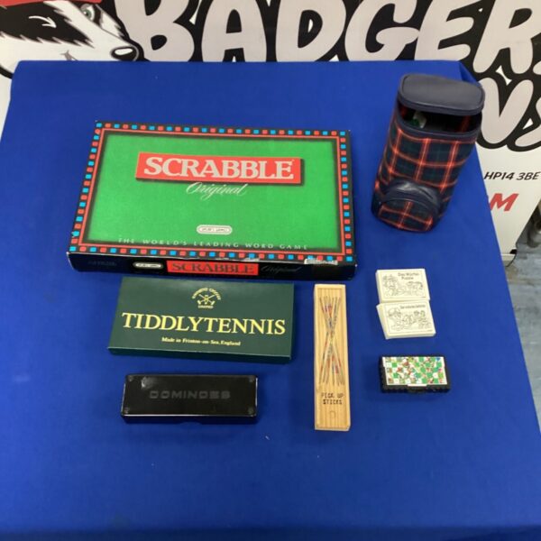 Vintage games lot featuring Scrabble, Tiddly Tennis, and Pick Up Sticks.