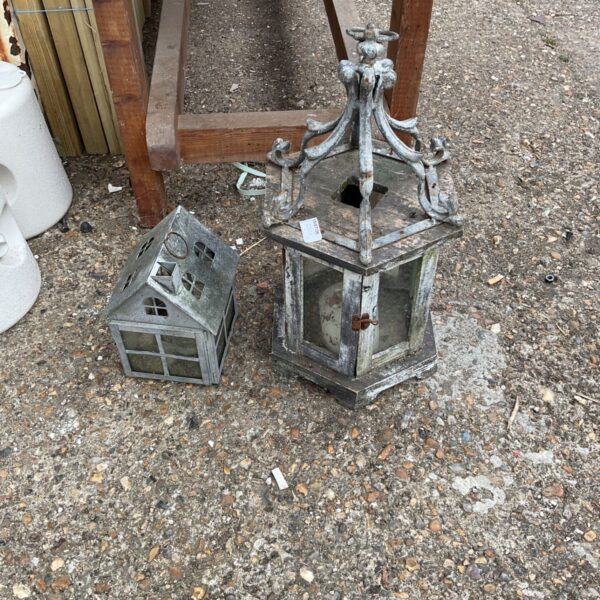 Ornate vintage metal garden lanterns with detailed design.