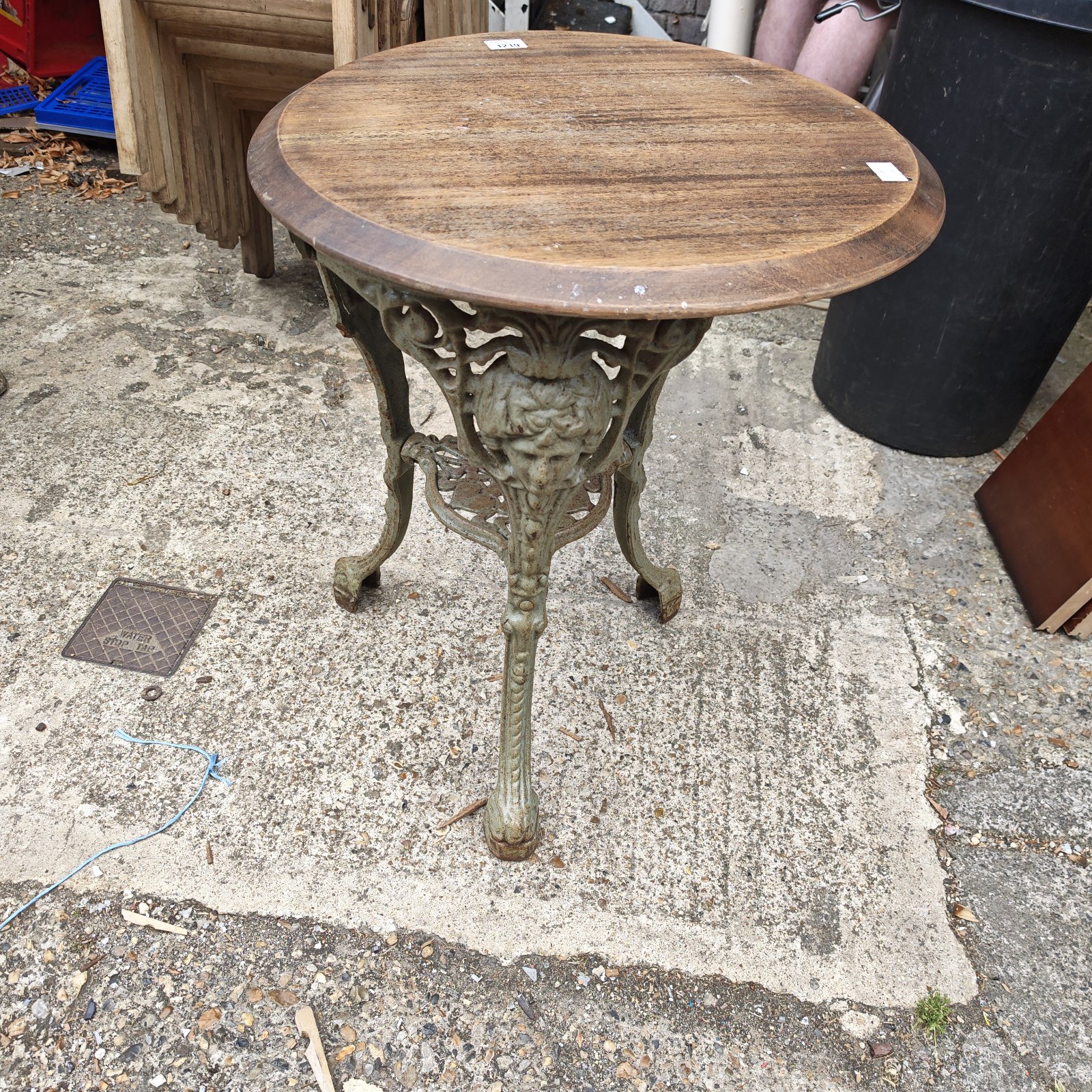 Intricate iron base vintage garden table with wooden top.