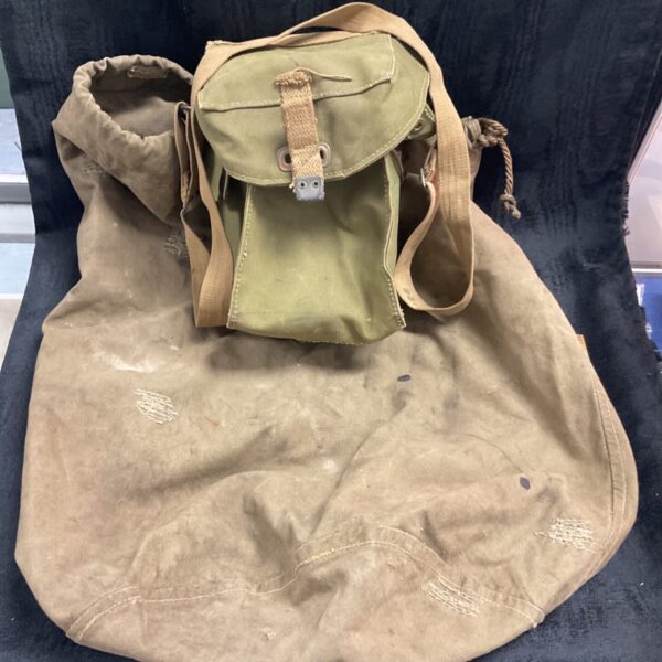 Vintage British army gas mask bag and kitbag set, showing wear.
