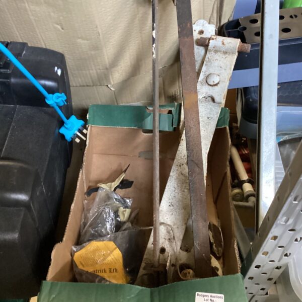 Vintage gate hinges in a box, antique hardware for garden restoration.