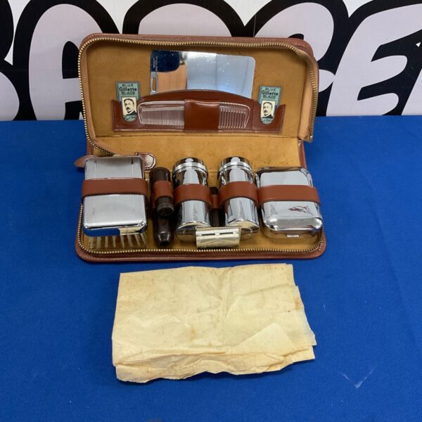 Vintage gentleman's grooming kit in a leather case, antique shaving tools.