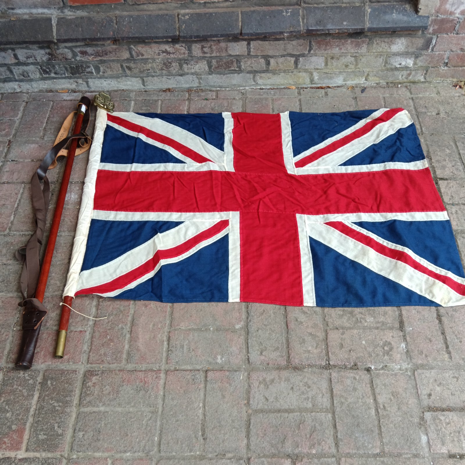 Vintage Girl Guide Union Flag displayed with pole and strap.