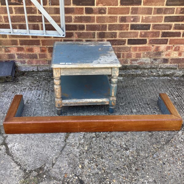 Vintage grey table with wooden mantel shelf for display.