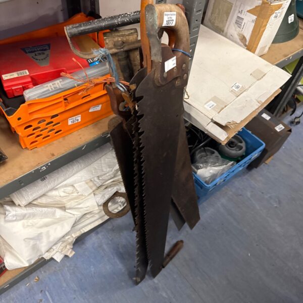 Vintage hand saws bundle with large saw and wooden handle.