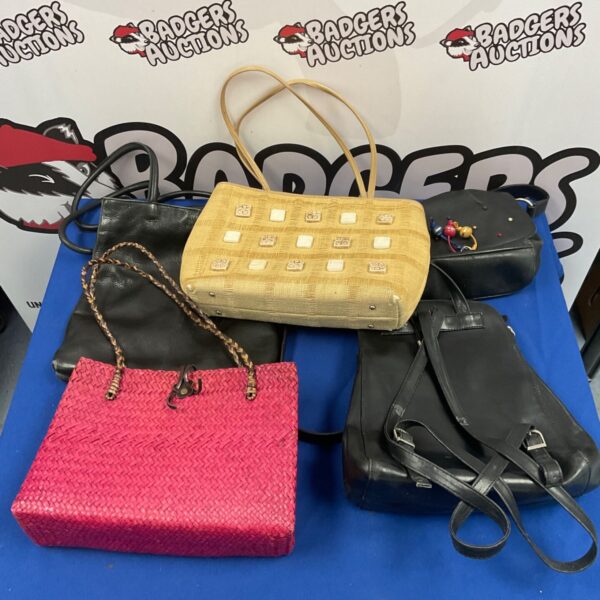Vintage handbag lot featuring pink woven purse and black leather bag.