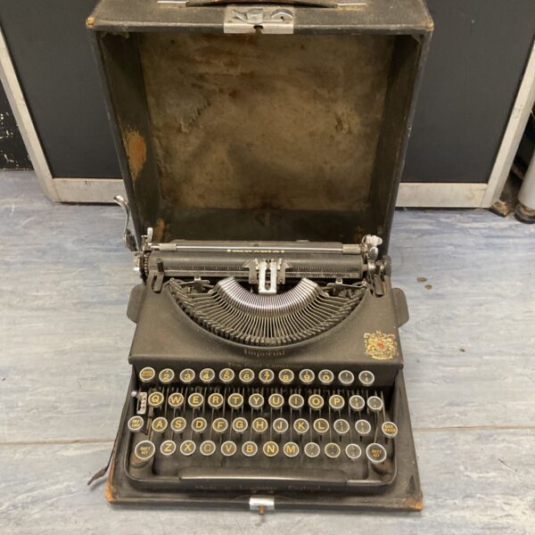 Vintage Imperial portable typewriter in black, a collectible antique.