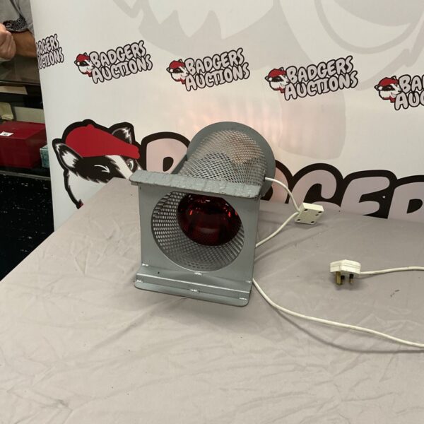 Vintage red guard infrared heat lamp for farm or industrial use.