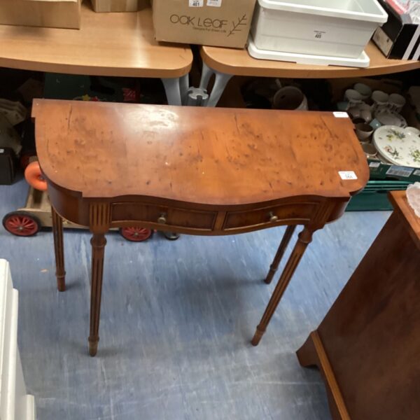 Vintage inlaid cabinet with two drawers and tapered legs.