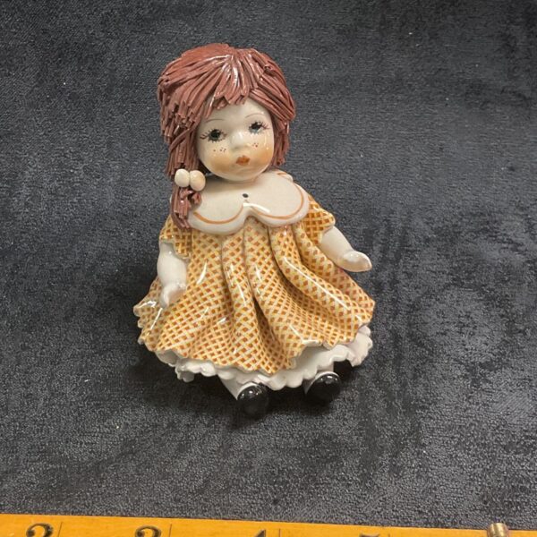 Vintage Italian porcelain Lisa doll figurine with orange dress.
