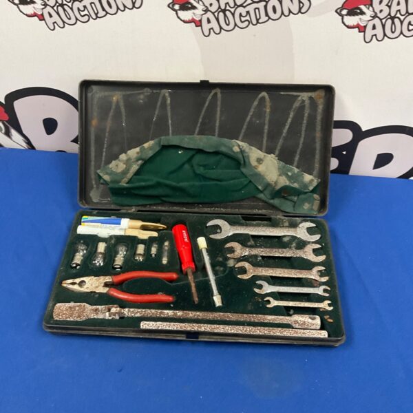 Open vintage Jaguar tool kit with tools inside.