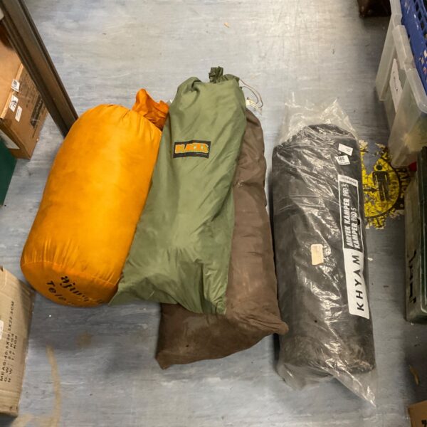 Vintage khaki sleeping bag, showing wear and tear.
