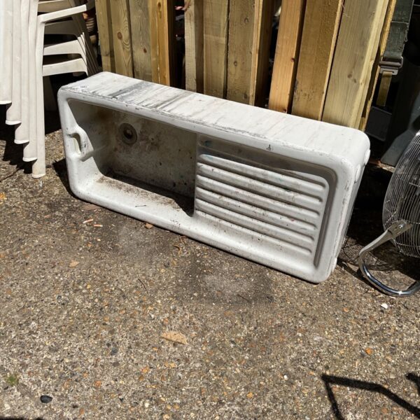 Vintage ceramic farmhouse kitchen sink with ribbed front.