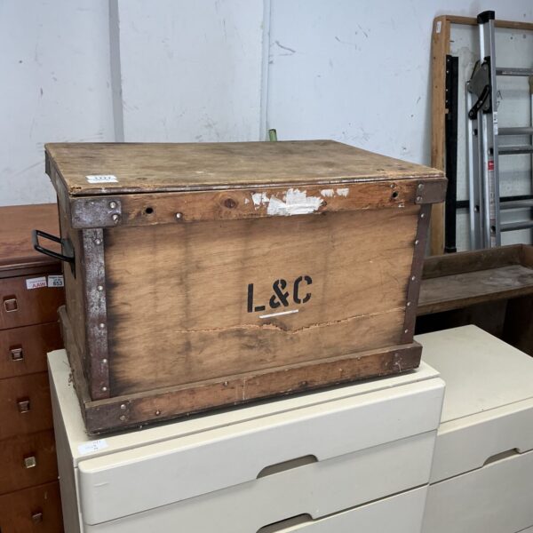 Vintage L&C wooden storage trunk with aged patina.
