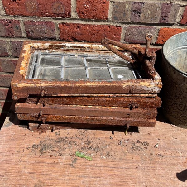 Set of three vintage leaded windows with rusted metal frames.