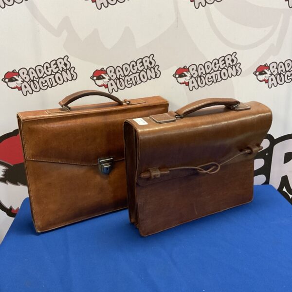 Vintage brown leather case with clasp and handle.