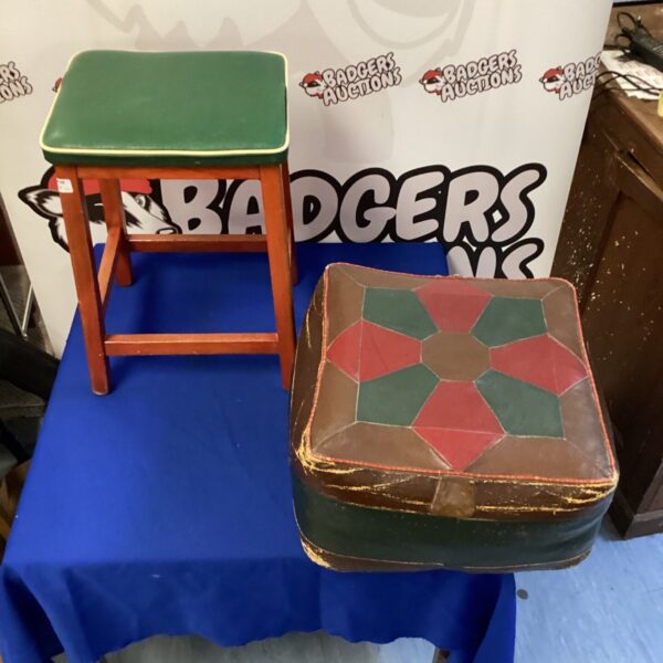 Vintage leather pouffe with stitched detailing, a retro footstool.