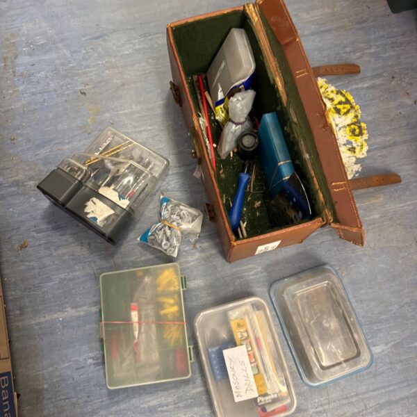Vintage leather tool case with assorted tools and fixings inside.