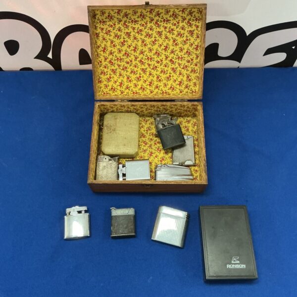 Vintage lighter collection in a floral wooden box.