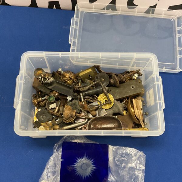 Vintage locks and handles in a plastic storage box.