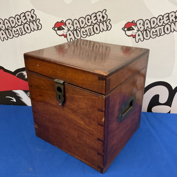 Vintage mahogany box with brass handle and keyhole.
