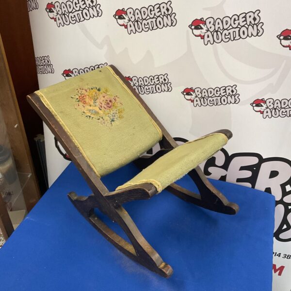 Vintage mahogany rocking chair with needlepoint upholstery.