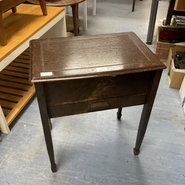 Vintage mahogany sewing table with lift-top for sewing supplies.