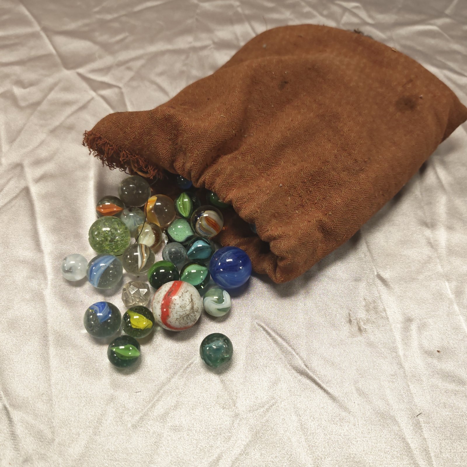 Vintage marbles in a burlap bag, a classic collector's item.