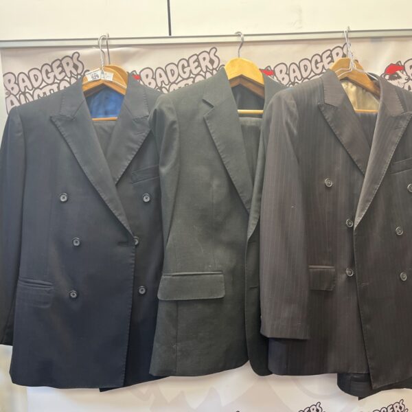 Three vintage men's pinstripe suits with extra trousers.