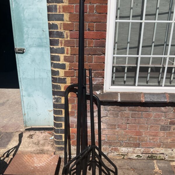 Vintage metal clothes rack for garment display and storage.