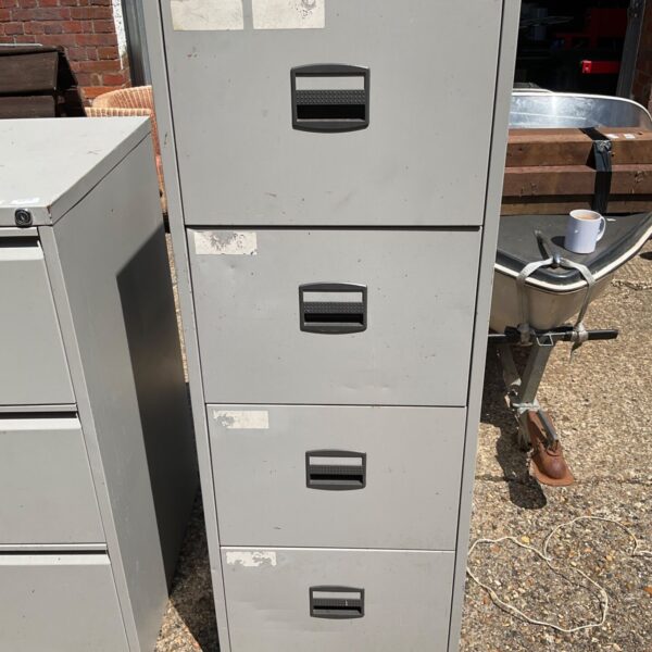 Vintage metal filing cabinet with four drawers, ideal for office storage.