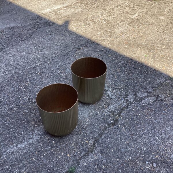 Two vintage metal garden tubs showing signs of wear.