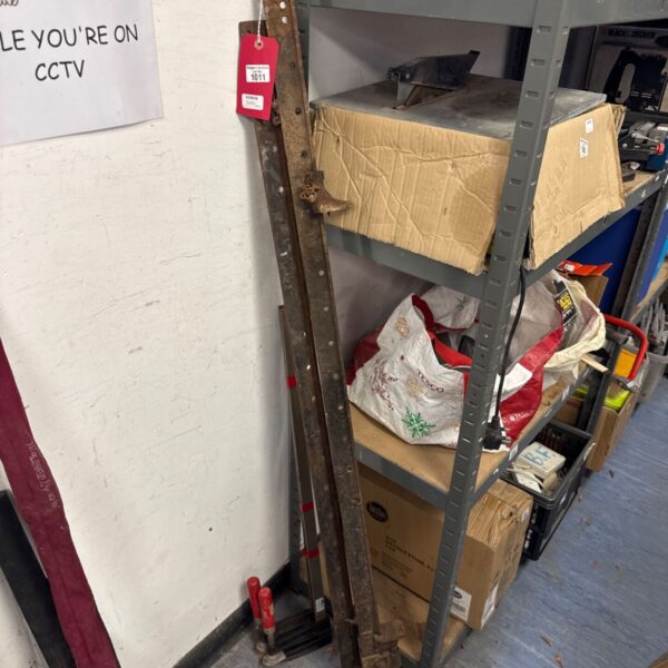 Vintage metal sash clamps for woodworking, showing signs of age.