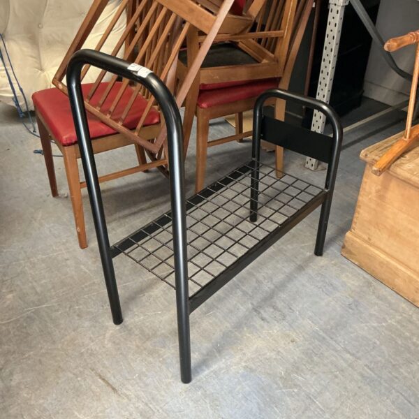Vintage metal shoe rack bench for hallway storage.