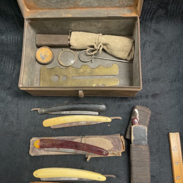 Vintage military shaving kit with razors and sewing supplies.