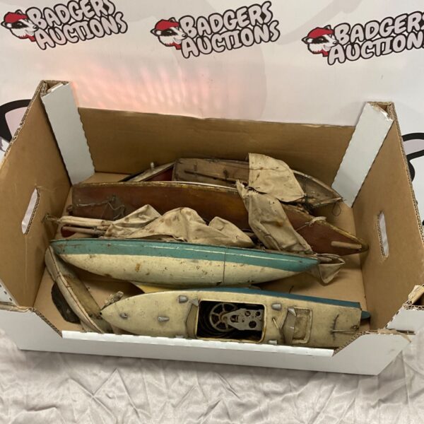 Box of vintage model boats and components for restoration.
