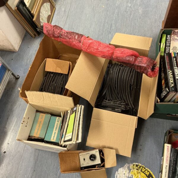 Vintage model train set lot with tracks and manuals.