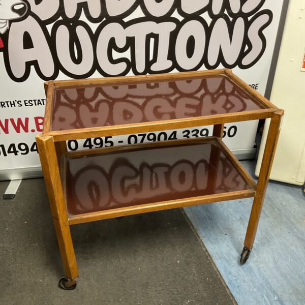 Vintage oak butlers trolley with enamel trays for serving.