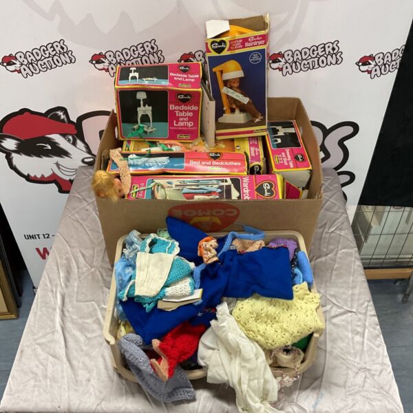 Vintage Pedigree Sindy doll lot with clothing and accessories.