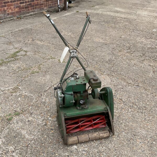 Vintage petrol lawn mower for garden restoration project.