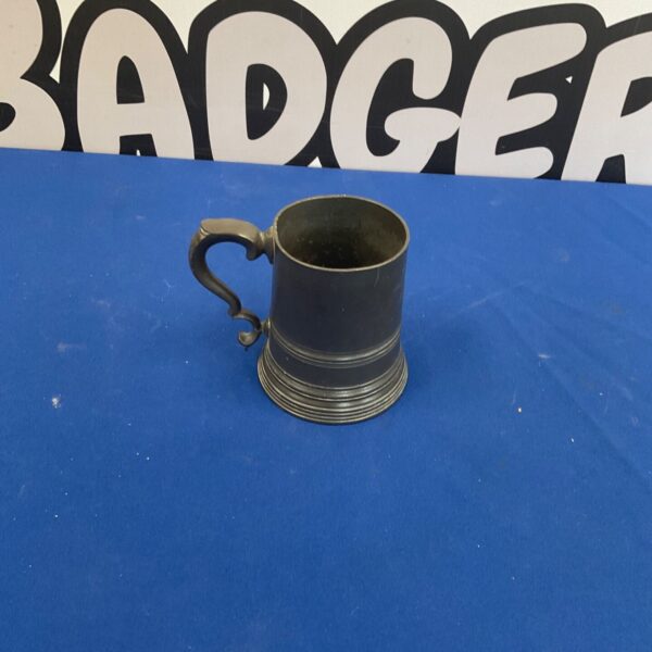 Vintage pewter tankard with a curved handle, ideal for collectors.