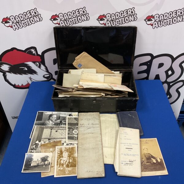 Vintage photograph collection inside a metal tin, antique images.