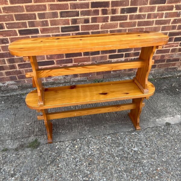 Vintage Scandinavian pine bench with natural wood grain.