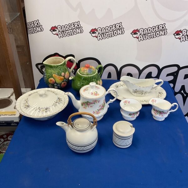 Vintage porcelain tea set with Queens pottery teapot and floral details.