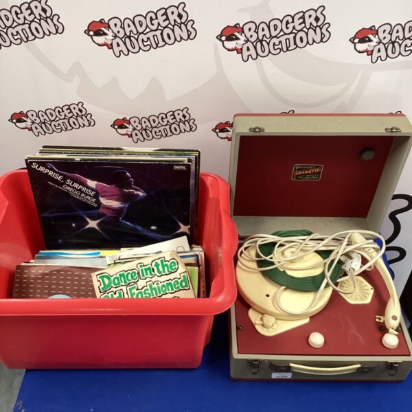 Vintage portable record player with red and grey casing.